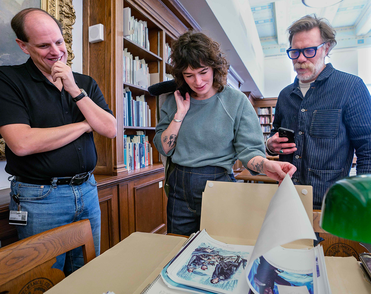 Lena Headey and Marc Menchaca ’98 view Game of Thrones fanart in a library reading room